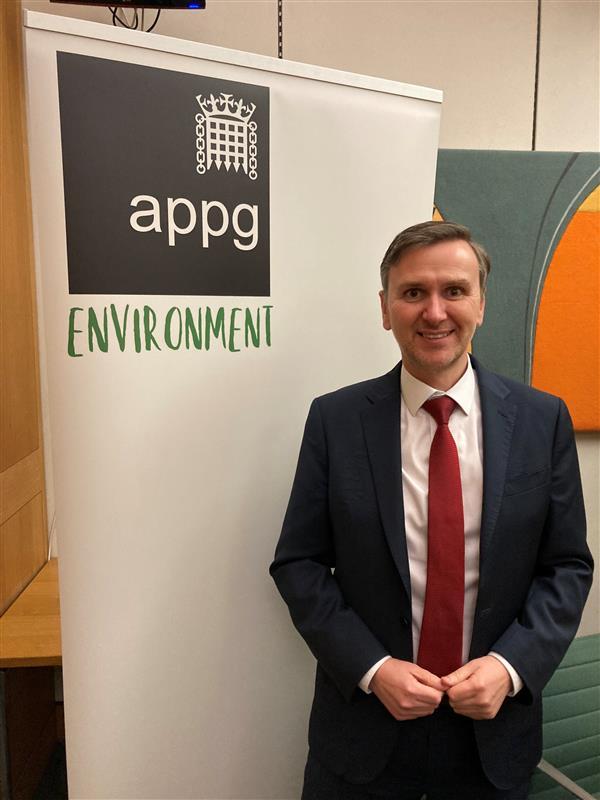 Andrew Pakes MP standing in front of Environment APPG banner