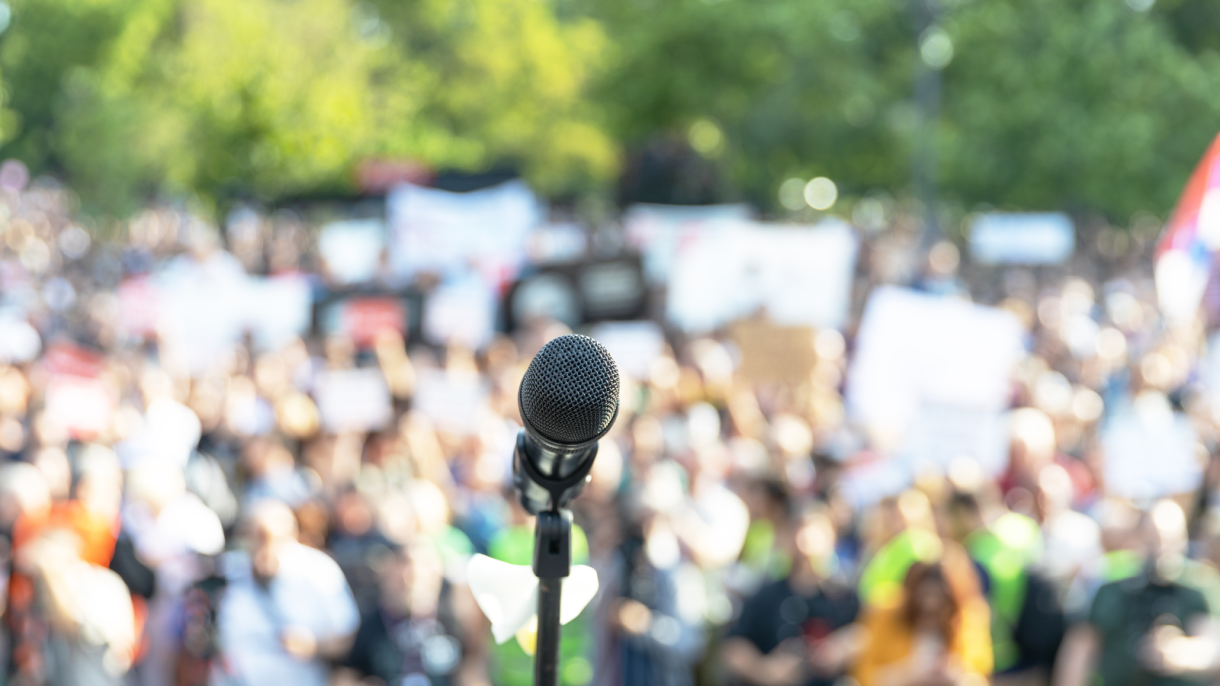 Image of microphone in front of a crowd