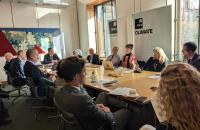 MPs, peers and scientists sit around a table