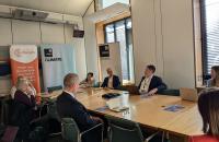 MPs sit and discuss around a table