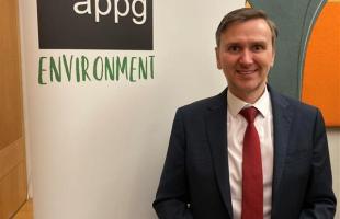 Andrew Pakes MP standing in front of Environment APPG banner